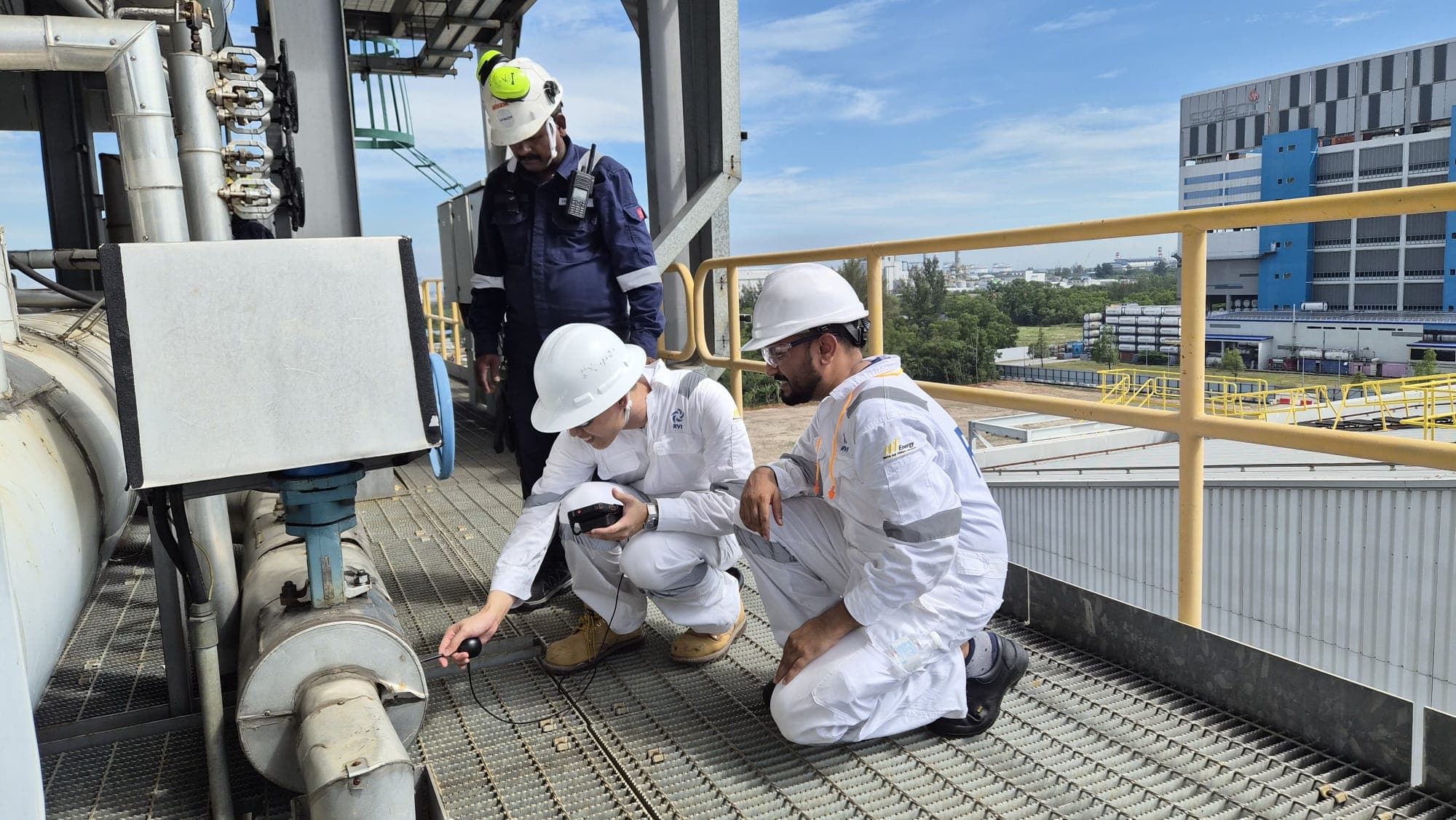 Field team inspecting a valve at an industrial plant