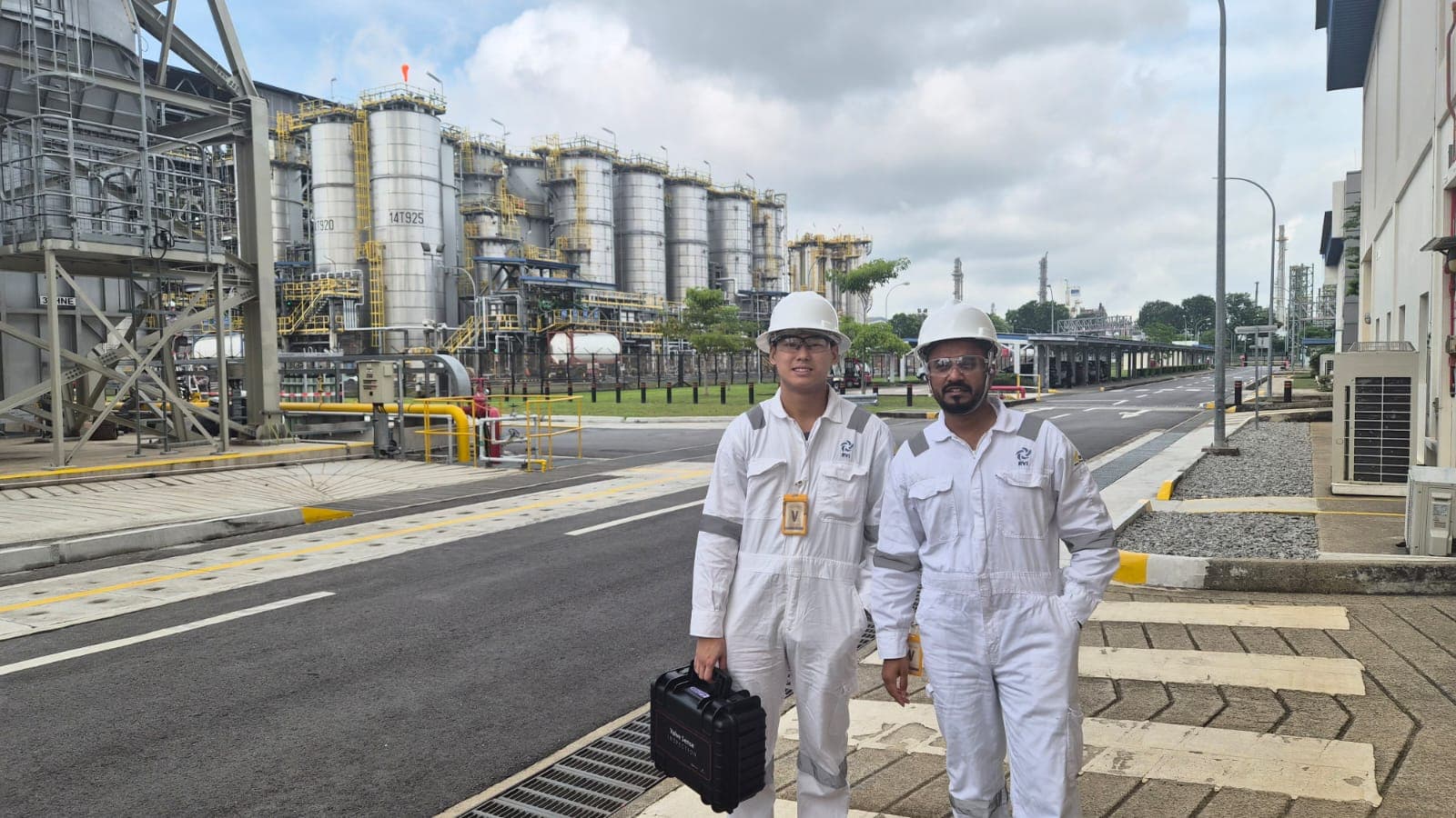 Two field technicians with a Valve Sense case at a refinery