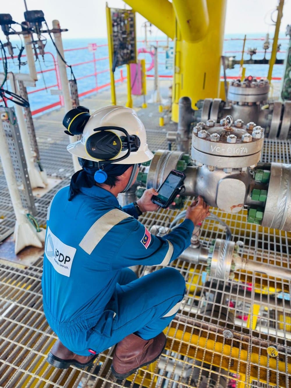 Technician testing a valve with Valve Sense on an offshore platform in Malaysia